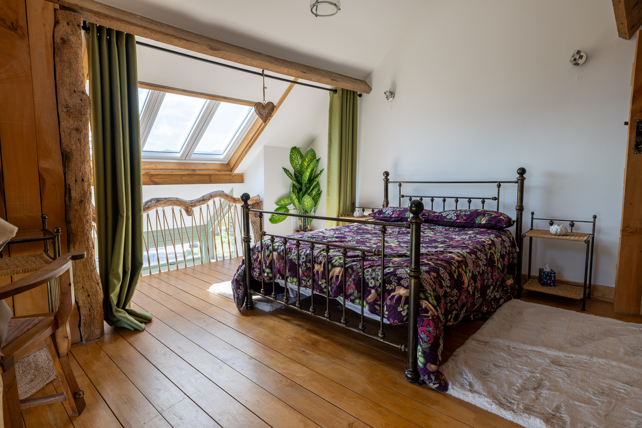 The light-filled bedroom with exposed timber beams
