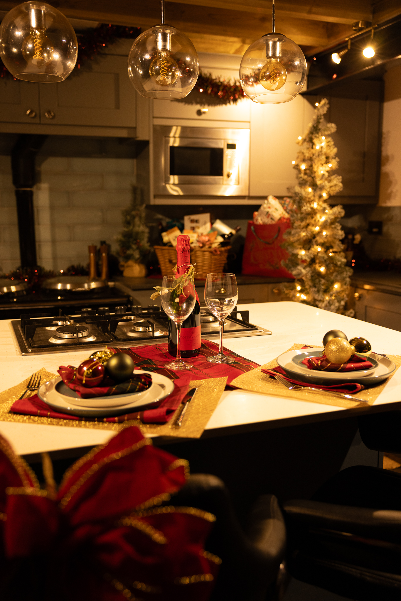 The cottage kitchen dressed for Christmas with a festive table and tree
