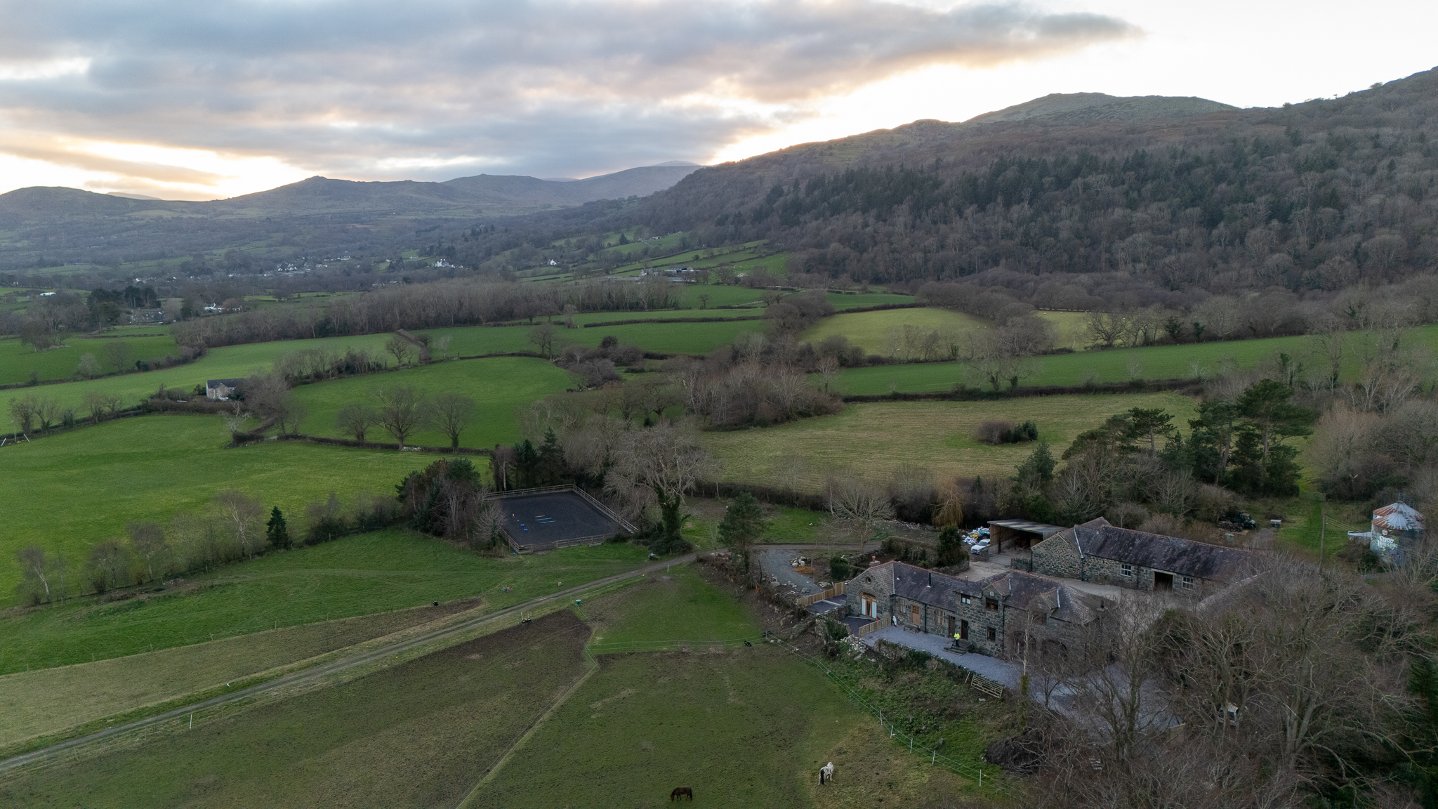 An aerial view across the fields and mountains of the Conwy Valley