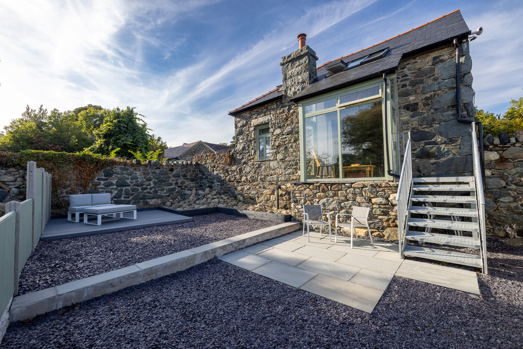 The stone exterior and private terrace of Tree of Life Cottage