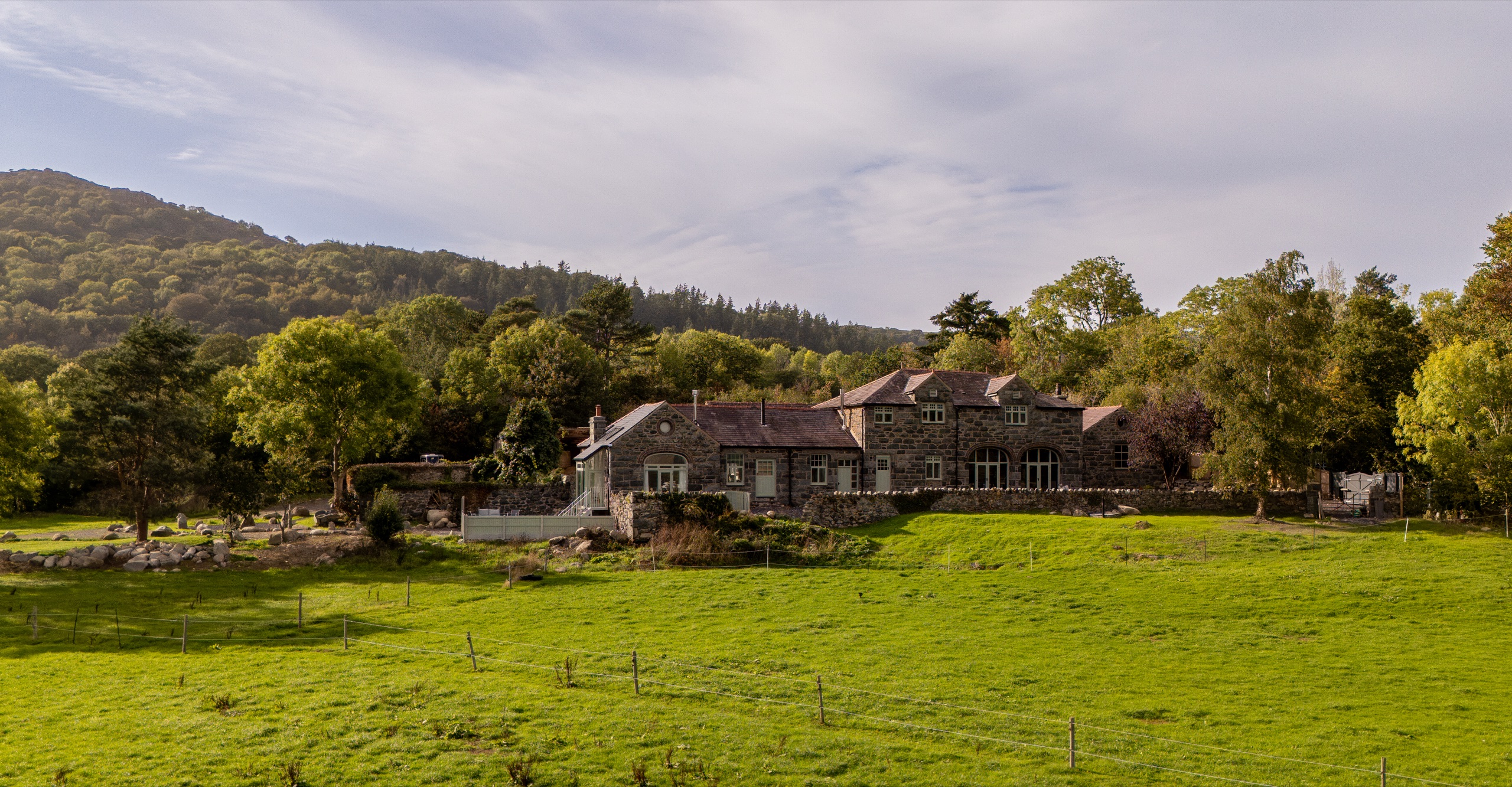 The Tree of Life Cottage and its historic stone buildings in the Conwy Valley