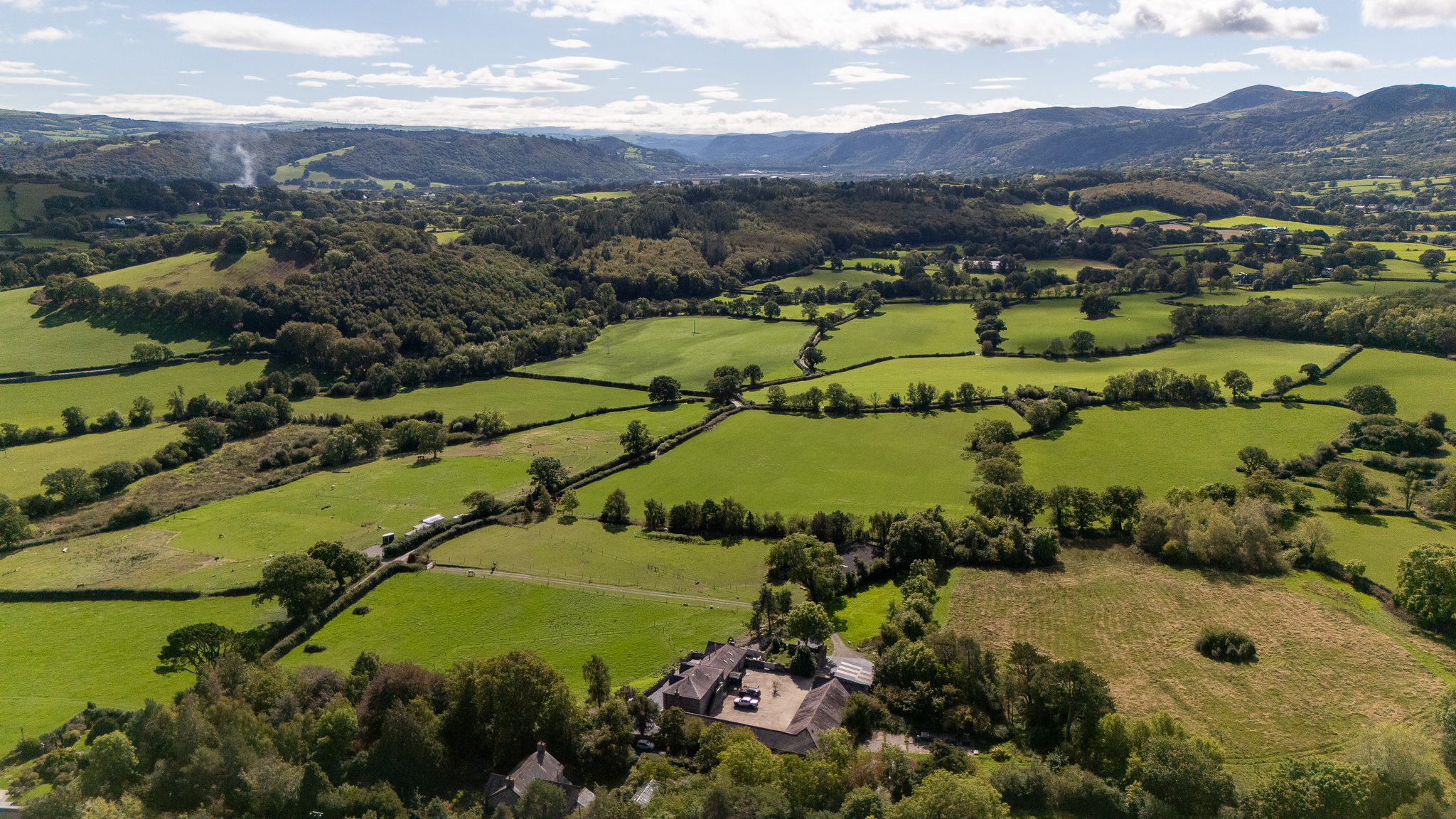 Aerial view across fields and mountains near the cottage